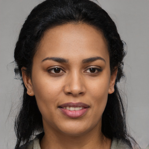 Joyful latino young-adult female with long  black hair and brown eyes