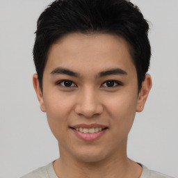 Joyful asian young-adult male with short  black hair and brown eyes