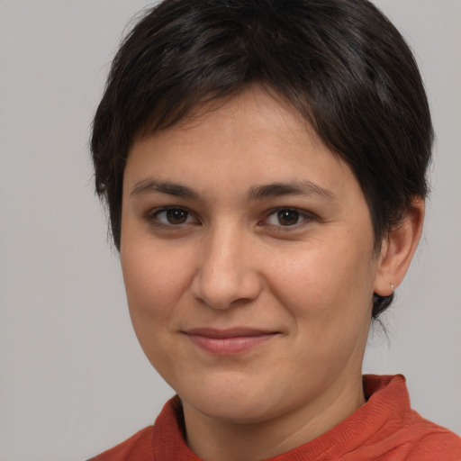 Joyful white young-adult female with short  brown hair and brown eyes