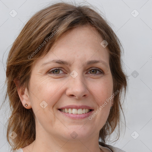 Joyful white adult female with medium  brown hair and grey eyes