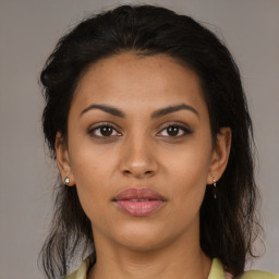 Joyful latino young-adult female with medium  brown hair and brown eyes