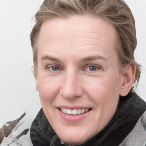 Joyful white adult female with medium  brown hair and blue eyes