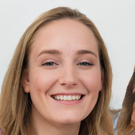 Joyful white young-adult female with long  brown hair and blue eyes