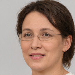 Joyful white adult female with medium  brown hair and grey eyes