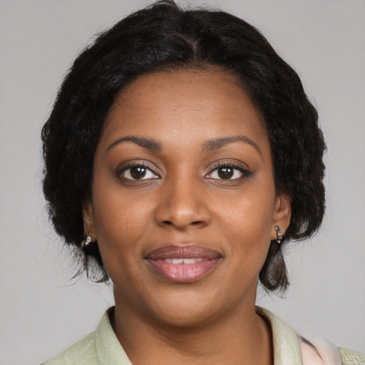 Joyful black young-adult female with medium  brown hair and brown eyes