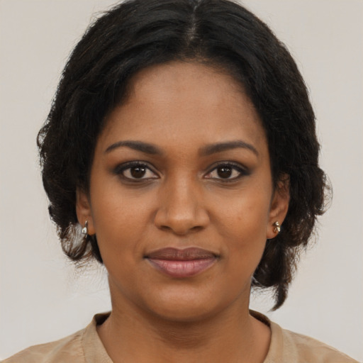 Joyful black young-adult female with medium  brown hair and brown eyes