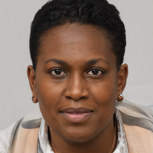 Joyful black young-adult female with short  brown hair and brown eyes