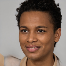 Joyful black young-adult male with short  brown hair and brown eyes