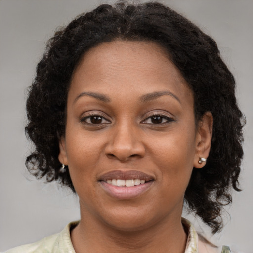 Joyful black young-adult female with medium  brown hair and brown eyes