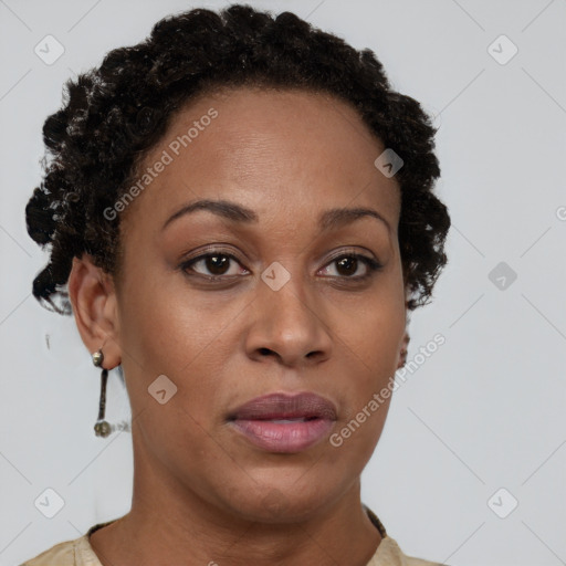 Joyful black adult female with short  brown hair and brown eyes