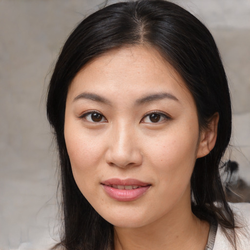 Joyful asian young-adult female with medium  brown hair and brown eyes