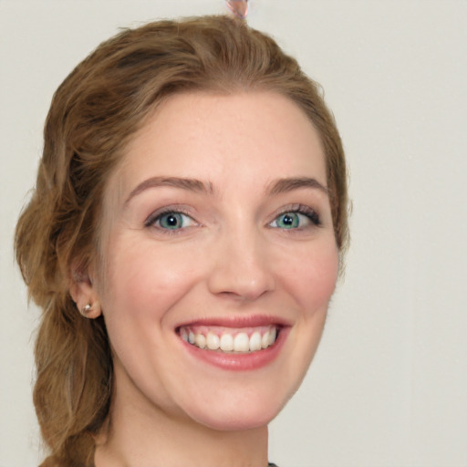 Joyful white young-adult female with long  brown hair and green eyes