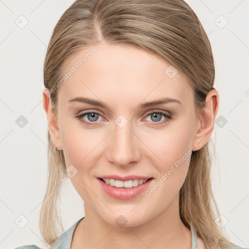 Joyful white young-adult female with medium  brown hair and blue eyes