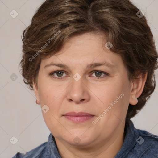 Joyful white adult female with medium  brown hair and blue eyes