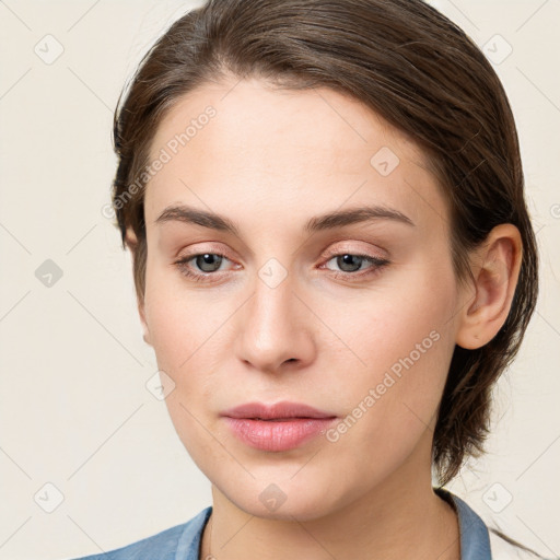 Joyful white young-adult female with long  brown hair and grey eyes