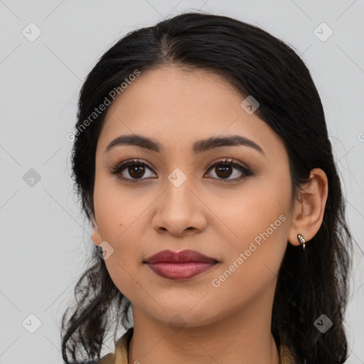 Joyful latino young-adult female with long  black hair and brown eyes