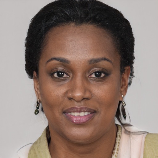 Joyful black adult female with short  brown hair and brown eyes