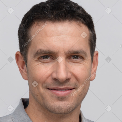 Joyful white adult male with short  brown hair and brown eyes