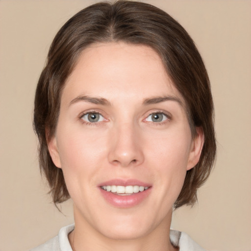 Joyful white young-adult female with medium  brown hair and green eyes