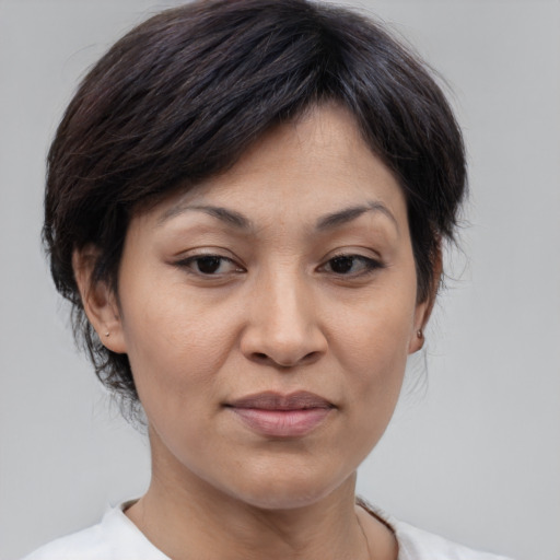 Joyful asian adult female with medium  brown hair and brown eyes