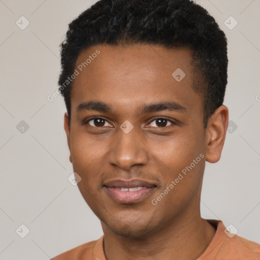 Joyful black young-adult male with short  black hair and brown eyes