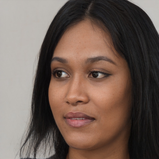 Joyful asian young-adult female with long  black hair and brown eyes