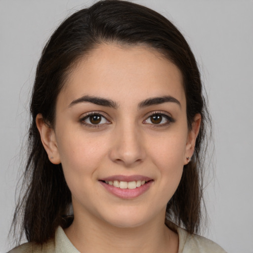Joyful white young-adult female with medium  brown hair and brown eyes