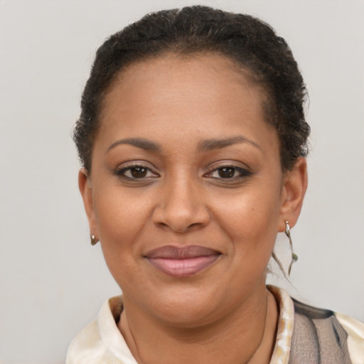 Joyful latino adult female with short  brown hair and brown eyes