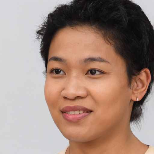 Joyful asian young-adult female with short  black hair and brown eyes