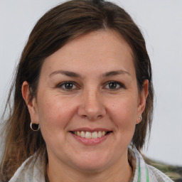 Joyful white adult female with medium  brown hair and brown eyes