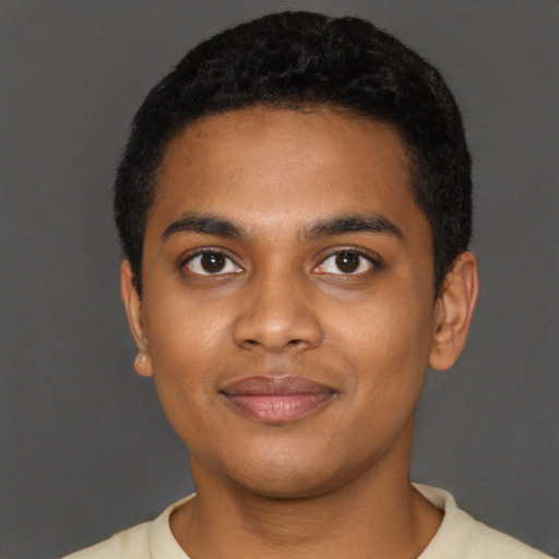 Joyful black young-adult male with short  black hair and brown eyes