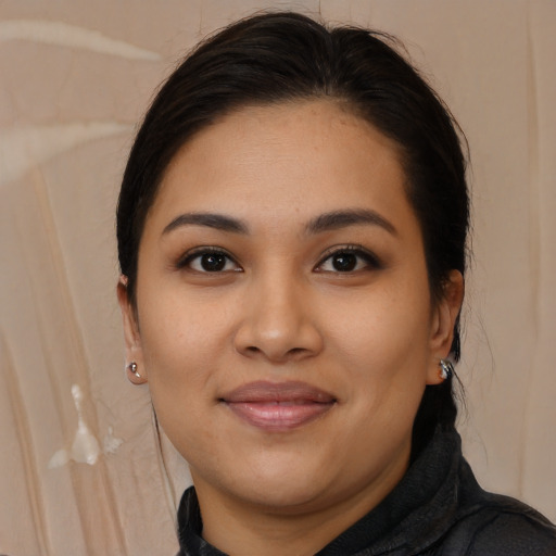 Joyful latino young-adult female with long  brown hair and brown eyes