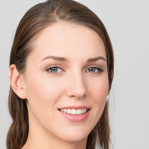 Joyful white young-adult female with long  brown hair and grey eyes