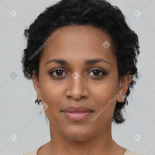 Joyful black young-adult female with short  black hair and brown eyes