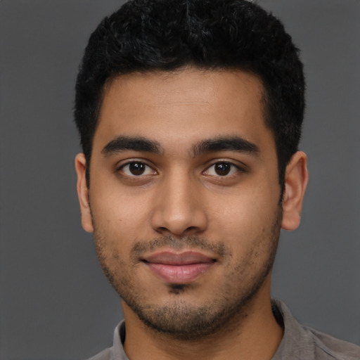 Joyful latino young-adult male with short  black hair and brown eyes