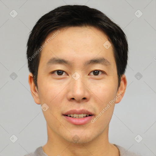 Joyful asian young-adult male with short  brown hair and brown eyes