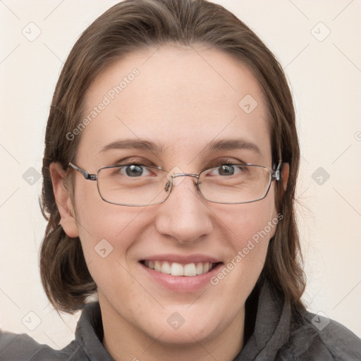 Joyful white adult female with medium  brown hair and grey eyes