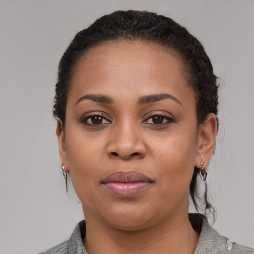 Joyful black young-adult female with medium  black hair and brown eyes