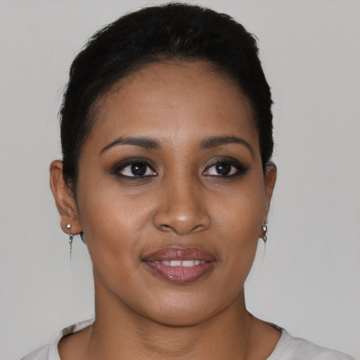 Joyful black young-adult female with short  brown hair and brown eyes