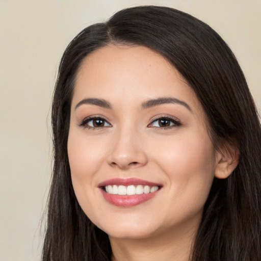 Joyful white young-adult female with long  black hair and brown eyes