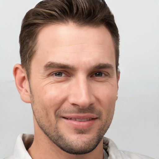 Joyful white adult male with short  brown hair and brown eyes