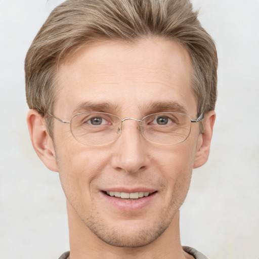 Joyful white adult male with short  brown hair and grey eyes