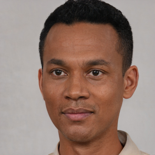Joyful black young-adult male with short  black hair and brown eyes