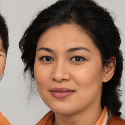 Joyful asian young-adult female with medium  brown hair and brown eyes