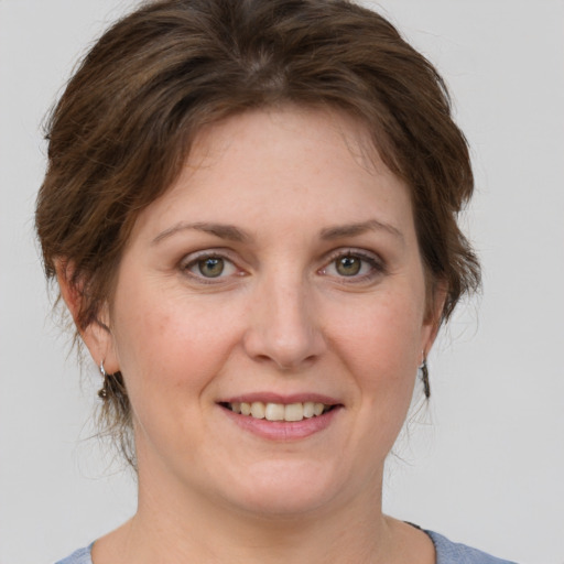 Joyful white adult female with medium  brown hair and grey eyes