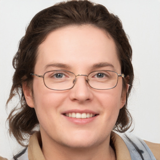 Joyful white adult female with medium  brown hair and grey eyes