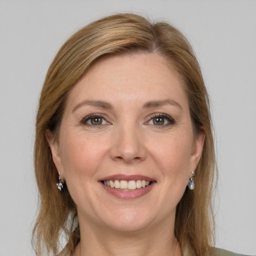 Joyful white adult female with medium  brown hair and grey eyes