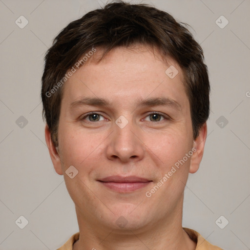 Joyful white young-adult male with short  brown hair and grey eyes