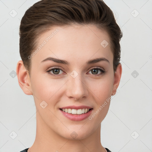 Joyful white young-adult female with short  brown hair and grey eyes