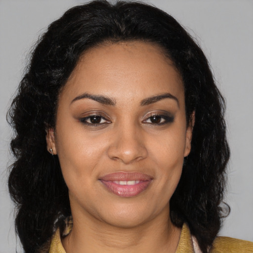 Joyful black young-adult female with long  brown hair and brown eyes